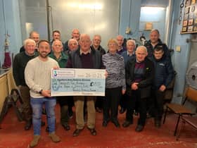 The Ferris family, friends & neighbours pictured presenting a cheque to James McCaffrey, Southern Area Hospice.