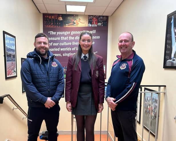 Caitlin Byrne pictured with one of her coaches Mr Bradley (left) and Mr Rafferty, Co-ordinator of Extra Curricular Sport. Not pictured: Mrs O’Hare. Credit: St Paul’s Facebook.