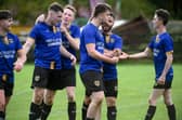 Millburn players congratulate winning goal scorer Sean McConville (third from right) after his second half strike at Jimmy McAlinden Park. Pic: Brendan Monaghan 