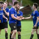 Millburn players congratulate winning goal scorer Sean McConville (third from right) after his second half strike at Jimmy McAlinden Park. Pic: Brendan Monaghan 