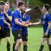 Millburn players congratulate winning goal scorer Sean McConville (third from right) after his second half strike at Jimmy McAlinden Park. Pic: Brendan Monaghan 
