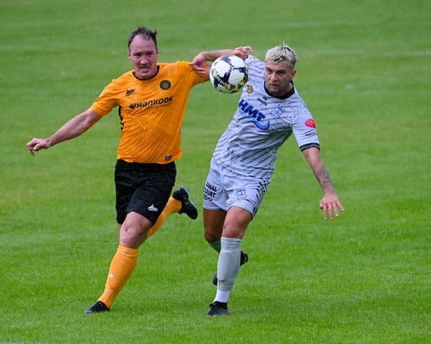 Newry's Adam Salley beats Carrick Rangers defender Albert Watson during the two sides' meeting in August.
