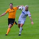 Newry's Adam Salley beats Carrick Rangers defender Albert Watson during the two sides' meeting in August.