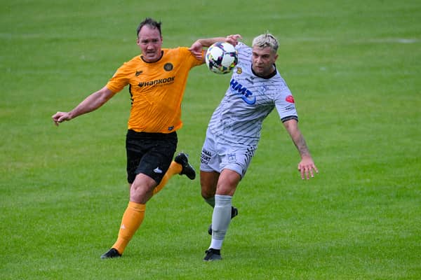 Newry's Adam Salley beats Carrick Rangers defender Albert Watson during the two sides' meeting in August.