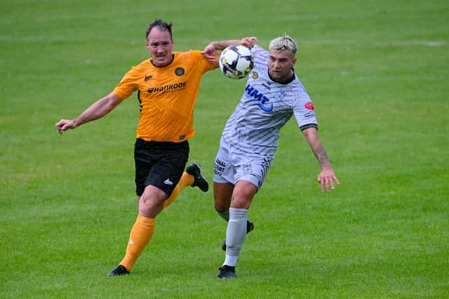 Newry's Adam Salley beats Carrick Rangers defender Albert Watson during the two sides' meeting in August.