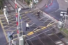 Woman hit by level crossing barrier.