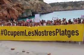 Majorca anti-mass tourism protesters ‘occupy’ beach.