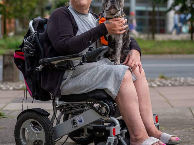Karen Bishop, 51, with her 2-year-old French bull dog Drew outside the Travelodge in Norwich.