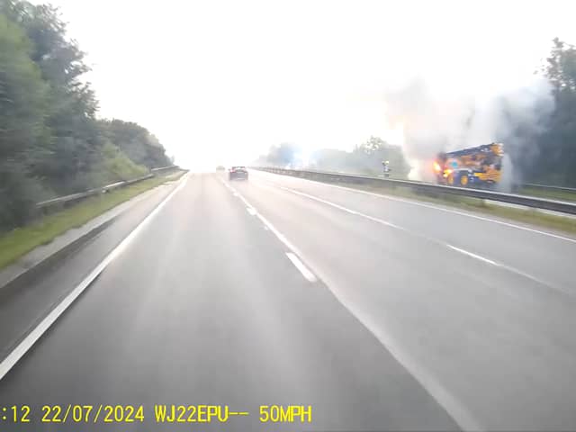 Fire rages through crane on A road as smoke billows into air.