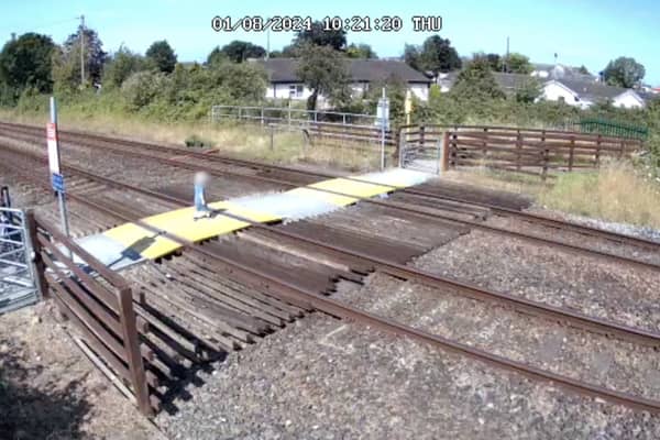 Toddler steps onto Sandy Lane level crossing in Prestatyn, North Wales.