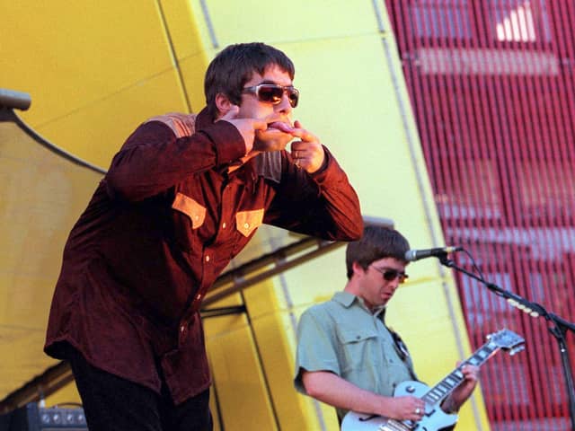 Liam and Noel Gallagher on stage in San Francisco in 1997 (Photo: Dave Hogan/Getty Images)