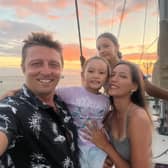 Dan Monk, his wife Bow, and their children Amelia and Olivia sailing on their yacht, Pancakes.