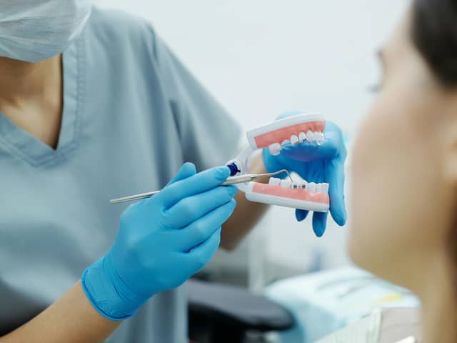 A dentist shows a patient how braces would look on the teeth. (Photo: Pexels/Cedric Fauntleroy)