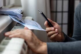 Man looks at his bills.