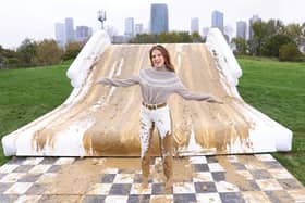 Binky Felstead encourages families to embrace the mud this half term as she's spotted going down a 2.5m high mudslide, created by Bosch at Mudchute Farm. 