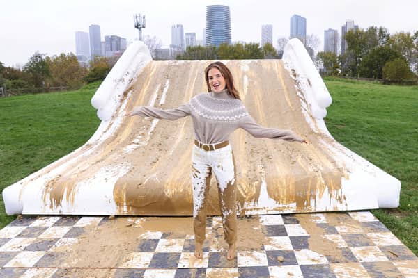 Binky Felstead encourages families to embrace the mud this half term as she's spotted going down a 2.5m high mudslide, created by Bosch at Mudchute Farm. 