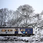 A Northern Rail train travels on tracks past snow in Buxton, northern England, on 19 November 2024 (Photo: PAUL ELLIS/AFP via Getty Images)