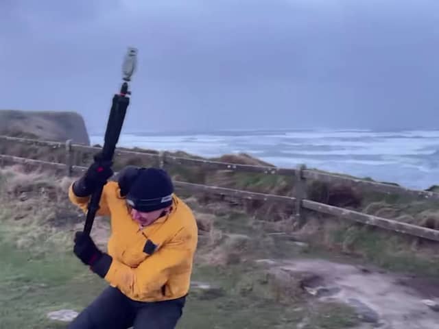 Video taken by the weather tracking group shows their team member battling against the strong winds while attempting to measure the wind speed. 