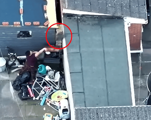 Drug dealer lobs bin bag of heroin over fence during police raid