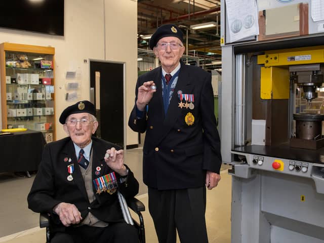 Veterans Richard Pelzer (left), 101, and Ron Horsey, 98, who both served with the Royal Engineers, holding the new VE Day 50p coin at the Royal Mint manufacturing site in South Wales (Photo: The Royal Mint)