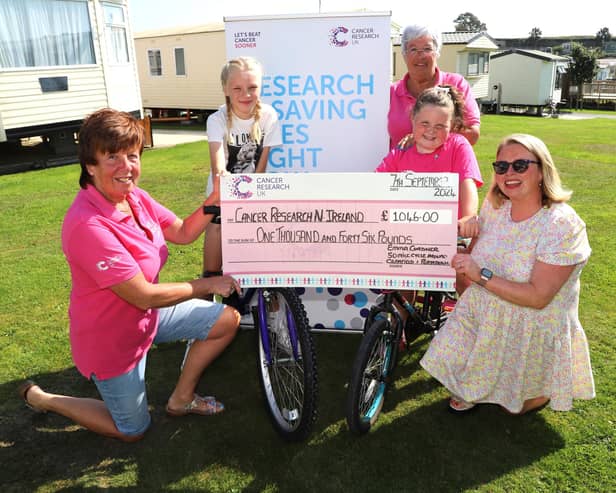 Emma Cordner (second right) with mum Kim and best friend Jasmine O'Neill hand over the cheque for £1046 to Rosalind McCullough and Hilary Ferris of Newry Cancer Research.  INNR3845