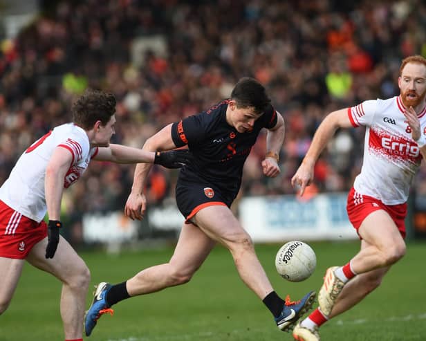 Armagh's Callum O'Neill drives past Derry's Ethan Doherty and Conor Glass during their league meeting in March.