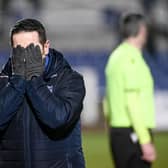 Newry City manager Darren Mullen holds his head in his hands.