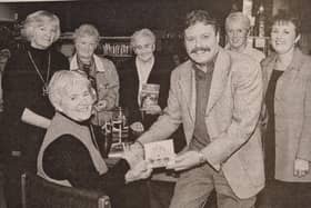 Danny Doran presents a copy of his Song for the Milleniun to best selling author Alice Taylor who took part in the last of the series of the 'Books Across The Border' community centre at Newry Library.
