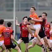 Armagh half-forward Tomás Oriate grabs a high ball despite attention from Down's Eoghan Convie at Pairc Esler Pictures: Brendan Monaghan