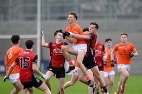 Armagh half-forward Tomás Oriate grabs a high ball despite attention from Down's Eoghan Convie at Pairc Esler Pictures: Brendan Monaghan