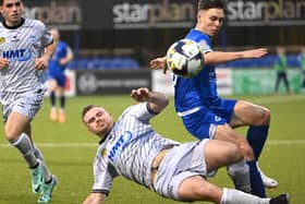 Dungannon’s Matthew Lusty is tackled by Newry’s Georgie Poynton. Picture: INPHO/Stephen Hamilton