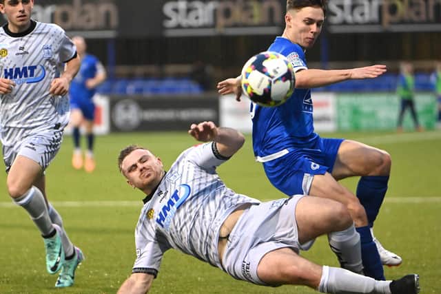 Dungannon’s Matthew Lusty is tackled by Newry’s Georgie Poynton. Picture: INPHO/Stephen Hamilton