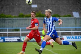 Newry City's Adam Salley with Loughgall's Ben Murdock.