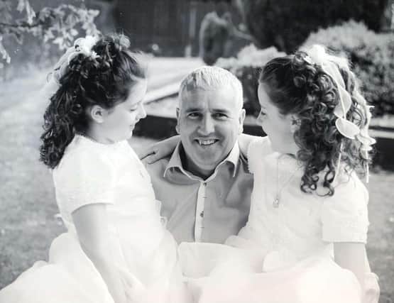 Katie and Anna Rowland with their dad, Jim.