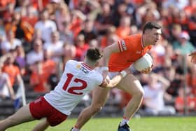 Armagh's Oisin Conaty breaks through a tackle from Tyrone's Ciaran Daly. Pics: Ulster GAA