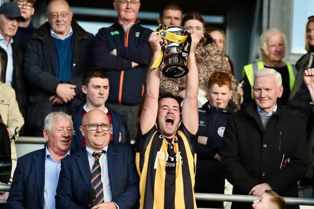 Crossmaglen Rangers captain Callum Cumiskey hoists the Gerry Fagan Cup after his side defeated Killeavy in Sunday's SFC Final. Pics: John Merry