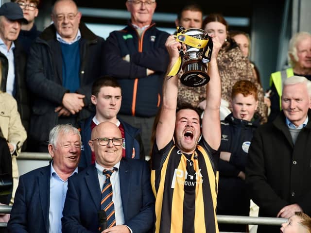 Crossmaglen Rangers captain Callum Cumiskey hoists the Gerry Fagan Cup after his side defeated Killeavy in Sunday's SFC Final. Pics: John Merry