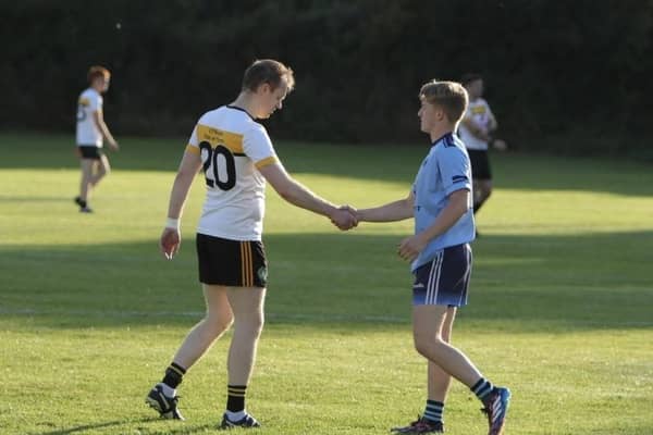 Redmond O'Hanlon's defender Kevin Smyth shakes hands with Ballyhegan attacker Aodhan McGrane. Pic: Armagh GAA