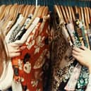 A person looking through vintage shirts