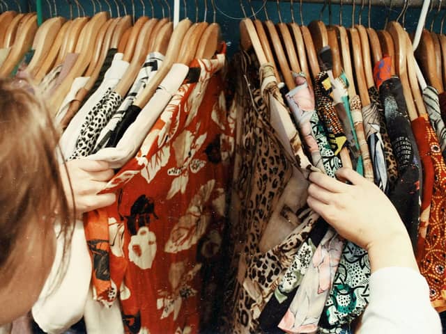 A person looking through vintage shirts