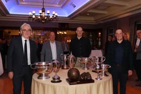 Cormac McKinney, Cathal Murray, Kevin Franklin, Ronan McMahon staff members organising committee standing at the table displaying the many trophies won by St. Colman's College. INNR4832