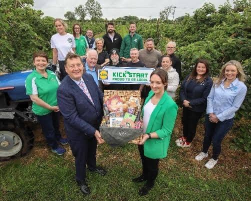 Back row L-R: Catherine McKeever (Long Meadow Cider), Helen Kettle (Mrs. K. Global), Alanna McKeever (Long Meadow Cider), Seamus McDaid (McDaid’s Football Special), (Symphonia Gin), Richard Robinson (Cloughbane Farm Foods), Brian McErlain (Berties Bakery). Row starting behind Michael: John O’Neill (Rosie’s Bakes), Lynne Murphy (Rosie’s Bakes), Tim McCarthy (Blackfire Food), Robert McGouran (Strangford Coffee), Darren Pritchard (Nocht), Perrine Bonnargent (Lecale Harvest), Esther Paul (Armagh Cider Company)