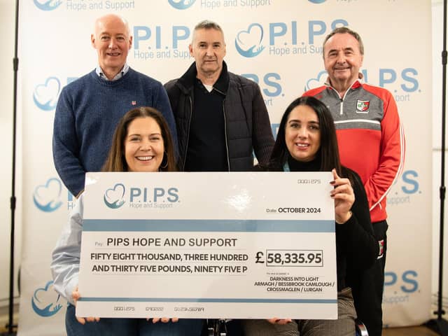 A cheque for £58,335.95 is presented to PIPS.