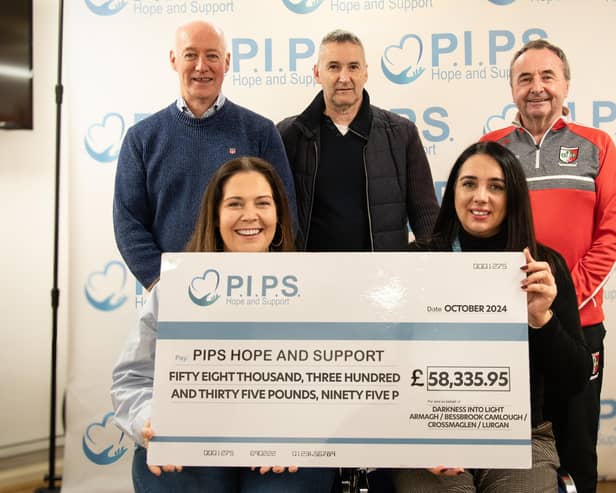 A cheque for £58,335.95 is presented to PIPS.