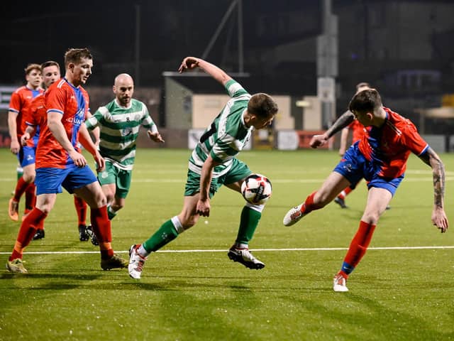 Opening goal scorer Davy Walker gets in between two Lincoln Courts defenders during Cleary Celtics Junior Cup semi-final victory at Stangmore Park