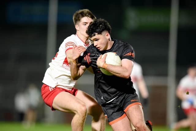 Armagh captain Calum O'Neill avoids a tackle from Derry forward Ryan McNicholl. Pictures: Brendan Monaghan