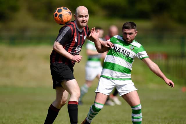 Archview United's James Kelly and Newry Celtic's Shane King battle for possession at Jennings Park. Pic: Brendan Monaghan