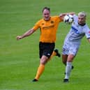 Newry City's Adam Salley and Carrick Rangers defender Albert Watson battle for possession.