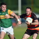 Kieran McCooey avoids a tackle from Mullaghbawn forward Tiarnan Murphy.