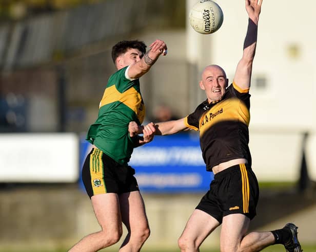 Shay Millar contest's a high ball with Bryansford Captain Sean Donegan at Mayobridge on Sunday. BM14